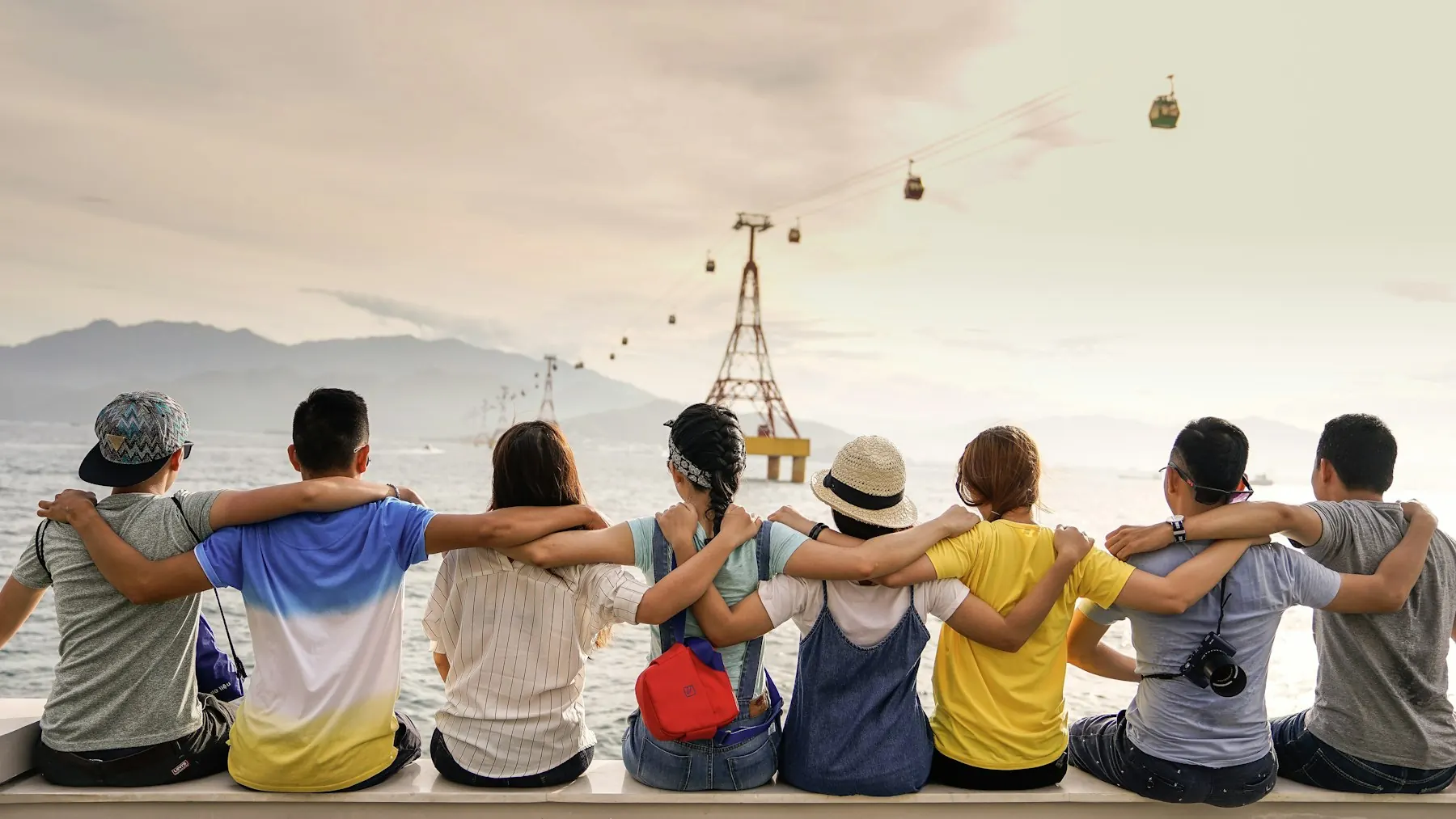 Friends gathered around a table, talking and laughing. Conceptual community imagery.