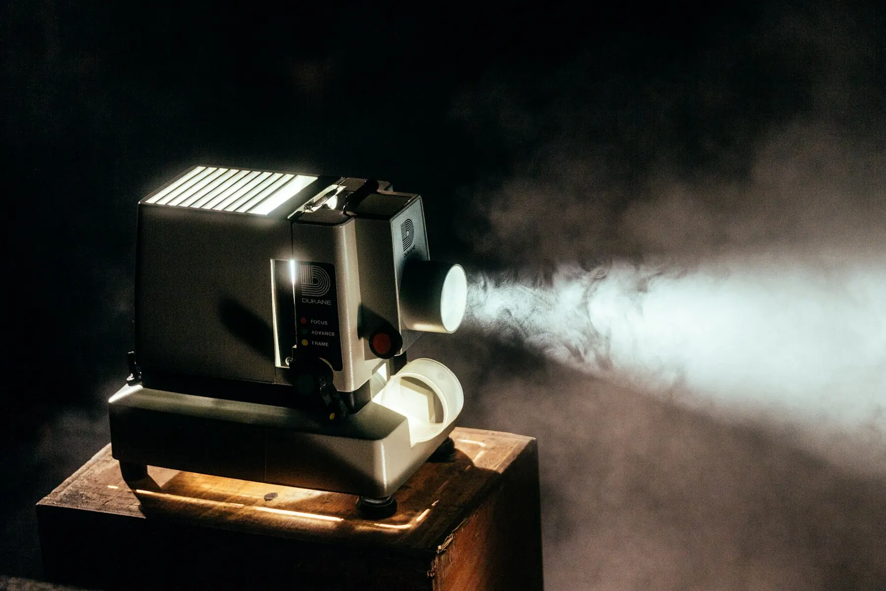 A film projector in a darkened theater. Conceptual movie-night imagery.