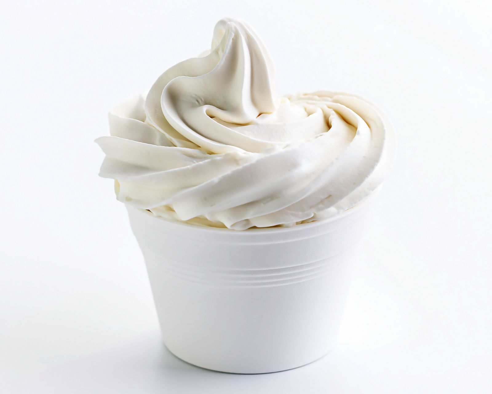 White soft-serve ice cream in a cup. Temporary concept photography.