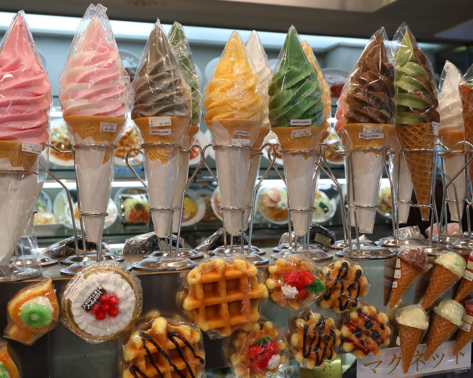 A variety of soft-serve ice cream cones on display. Temporary concept photography.