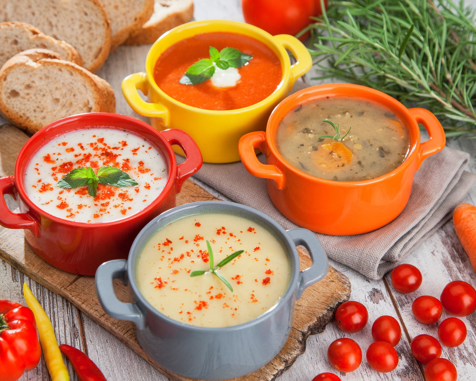 Colorful crocks of creamy and broth soups. Temporary concept photography.