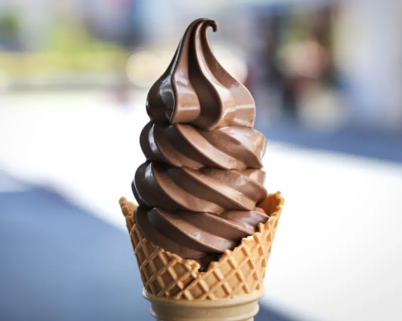 A chocolate soft-serve ice cream cone. Temporary concept photography.